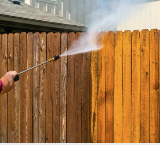 Pressure washing a wood fence before staining
